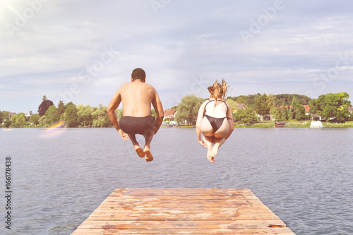 Couple Jumping Into Lake - Water bomb photo