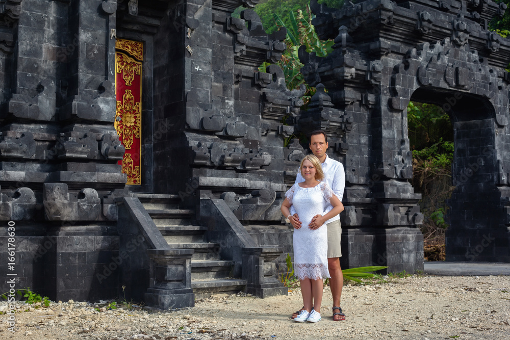 Romantic couple on the background of Bali temple