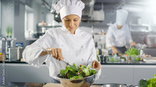 In a Famous Restaurant Female Cook Prepares Salad. She Works in a Big Modern Kitchen.