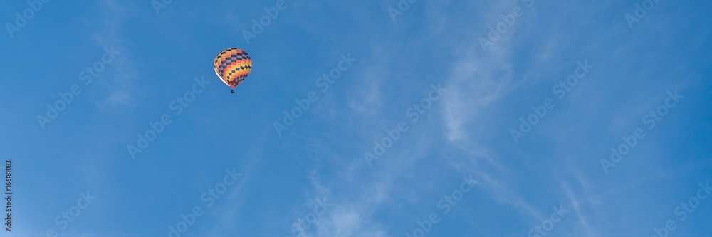 Colorful hot air balloon on bright blue sky Colorful hot air balloon on bright blue sky