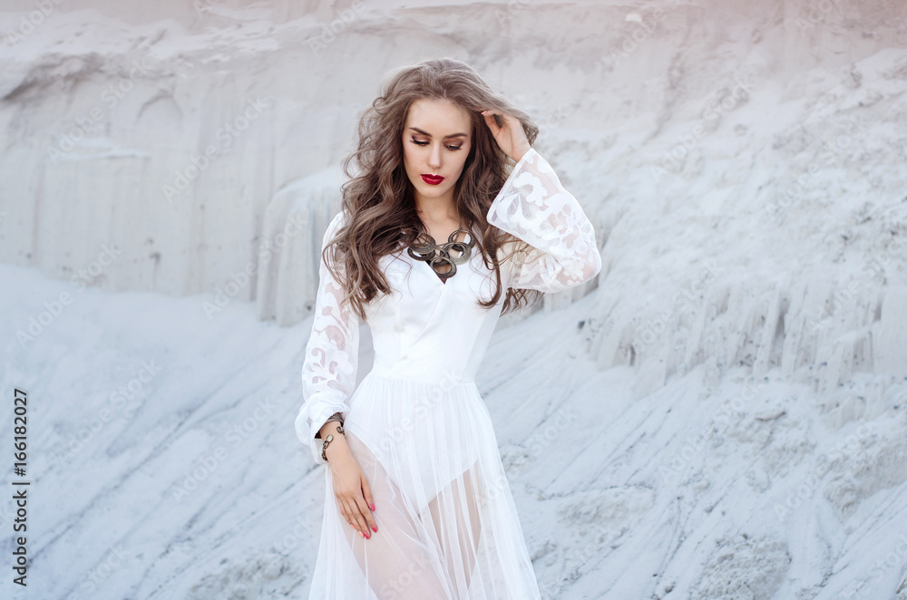 Attractive young woman in white long dress in the desert. Boho S Attractive young woman in white long dress in the desert. Boho S