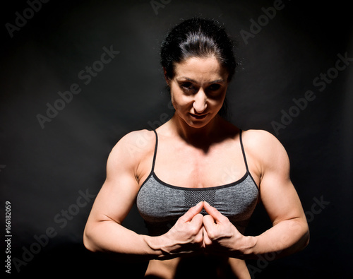Muscular bodybuilder woman showing her muscles.