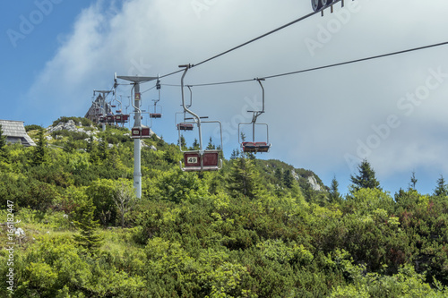 ski lift in summer transporting hikers onto mountain