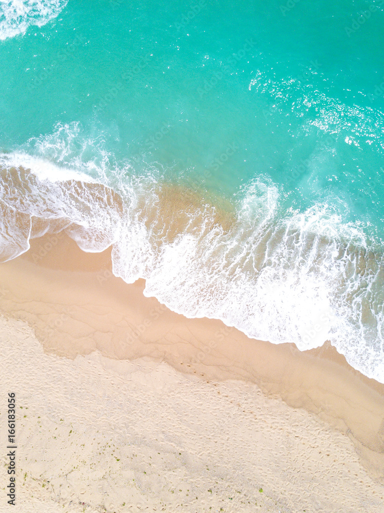 Aerial view of sandy beach and ocean with waves