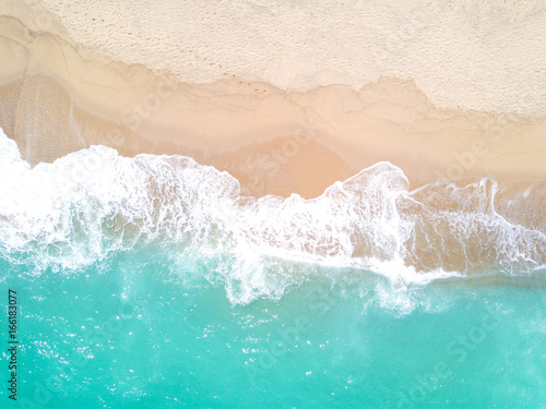 Aerial view of sandy beach and ocean with waves