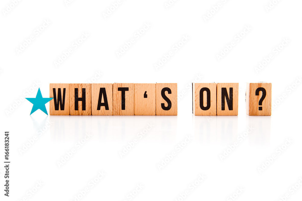 What's On? - wooden block letters on white reflective background with blue star shape What's On? - wooden block letters on white reflective background with blue star shape