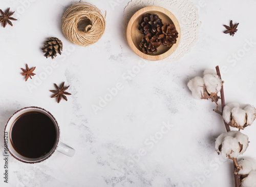 Coffee, cotton branch and other small objects on marble background