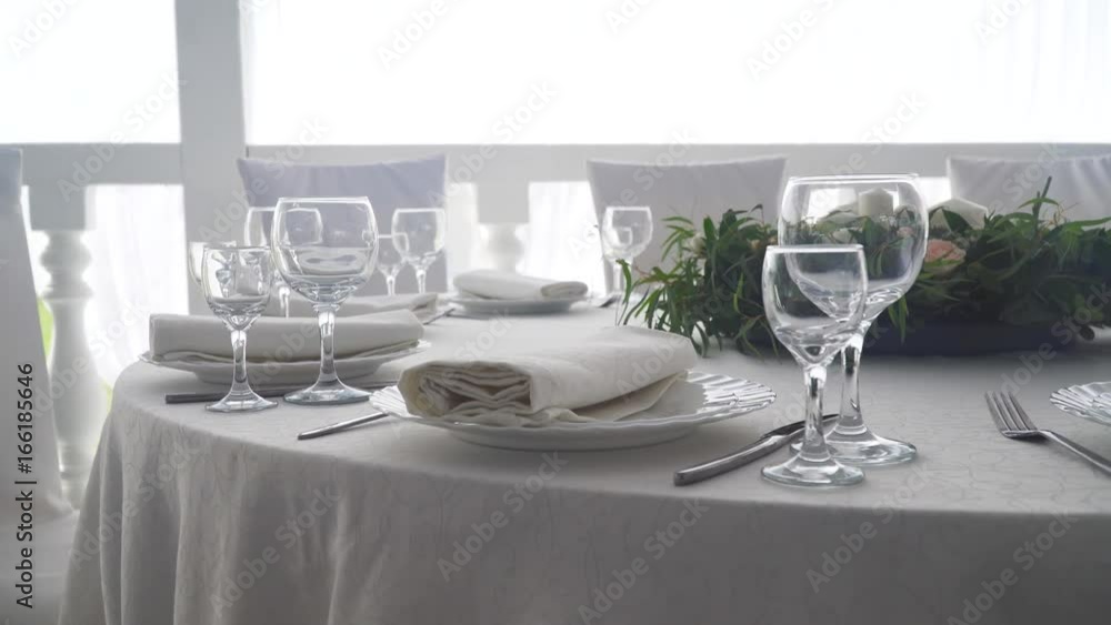 Banquet decorated table, with cutlery. Wedding decor in the banquet hall.Serving of a festive table, plate, napkin, knife, fork. Table setting decoration. Romantic Dinner or other events. Banquet decorated table, with cutlery. Wedding decor in the banquet hall.Serving of a festive table, plate, napkin, knife, fork. Table setting decoration. Romantic Dinner or other events.