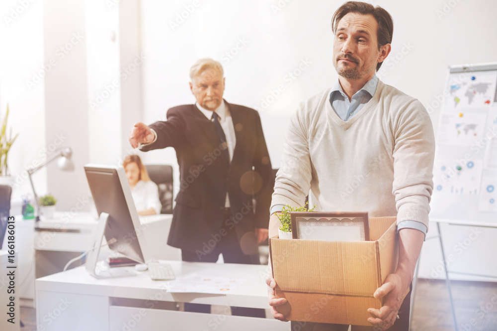 upset-fired-employee-being-asked-to-leave-the-building-stock-photo