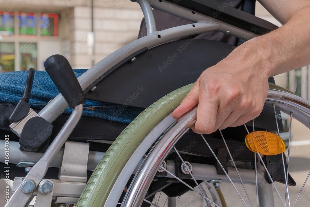 Handicapped disabled man sitting on wheelchair outdoors on street. Handicapped disabled man sitting on wheelchair outdoors on street.