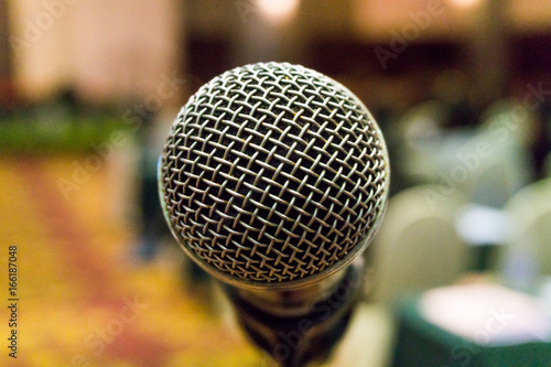 Microphone in conference room or seminar room, Abstract blurred background.