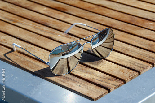 Sunglasses lie on the bench
