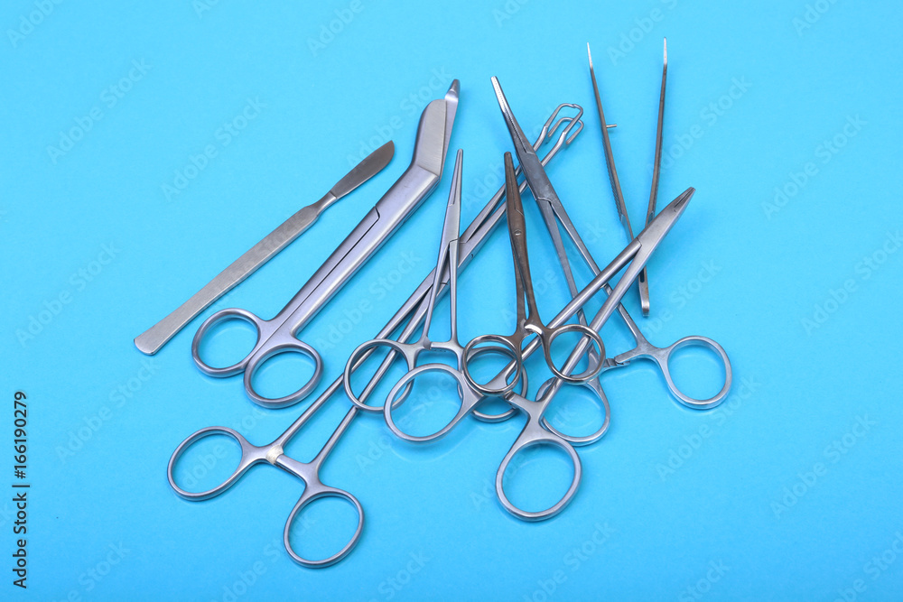 Close Up Surgical instruments and tools on blue mirror background. Selective focus. Close Up Surgical instruments and tools on blue mirror background. Selective focus.