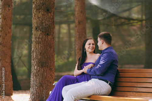 Girl in purple dress and a guy on a date in the park