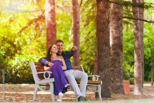 Girl in purple dress and a guy on a date in the park