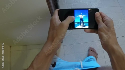 POV Of Man Sitting On Toilet Watching Photos While Angry Girl Open Door Taking Away Cell Smart Phone From Restroom