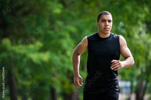african american sportsman running in park