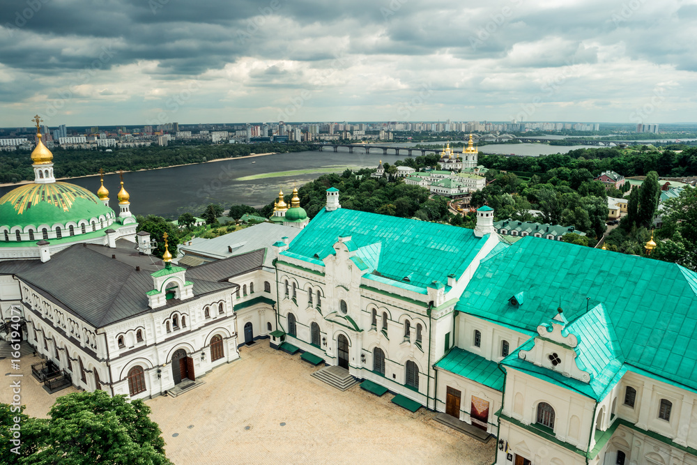 view of yard in Kyiv Pechersk Lavra and Kyiv cityscape from bell tower