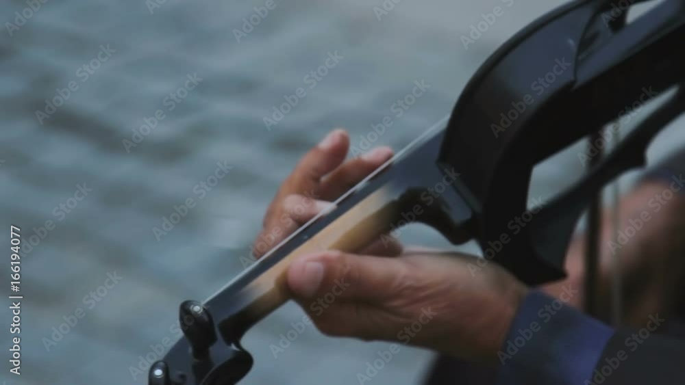 Hands of musician playing violin in an old town. Hands of musician playing violin in an old town.