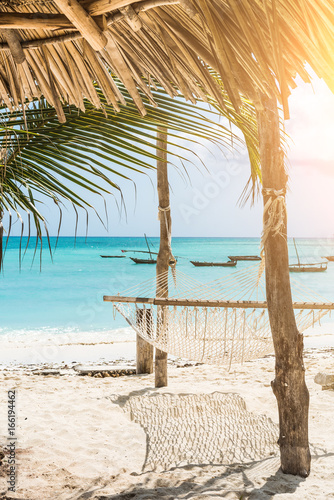 Fototapeta Naklejka Na Ścianę i Meble -  beautiful colorful seascape with hammock and palm on a beach