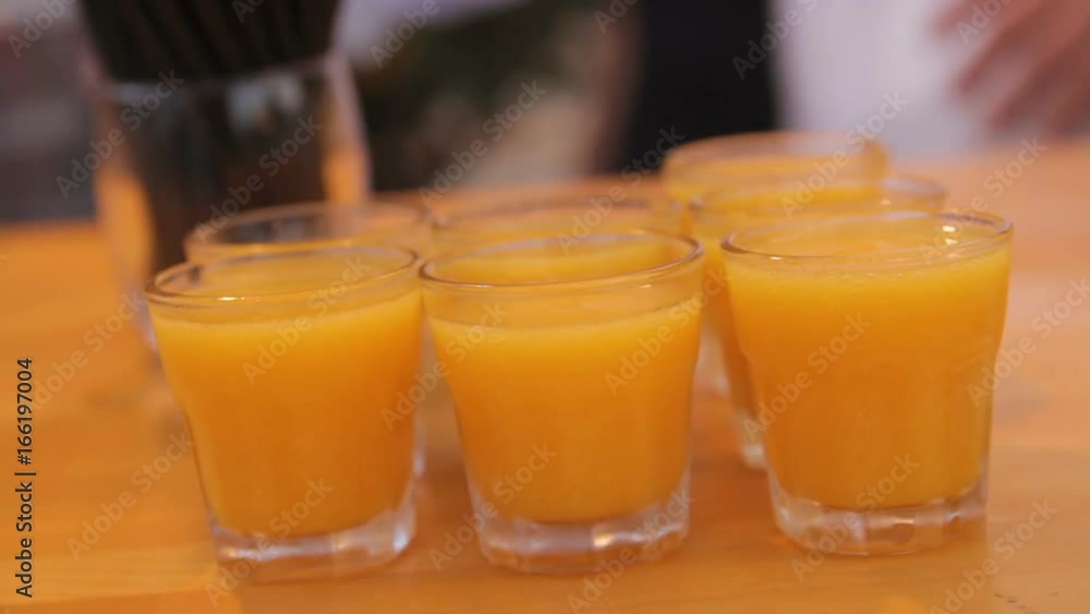 Many shot glasses with alcohol and citrus fruits juice Many shot glasses with alcohol and citrus fruits juice