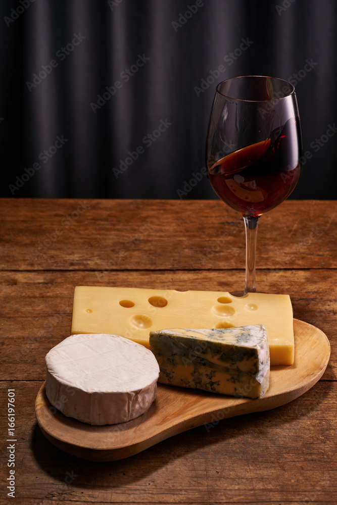 Wine with blue, Camembert and Gouda cheese with copy space Wine with blue, Camembert and Gouda cheese with copy space