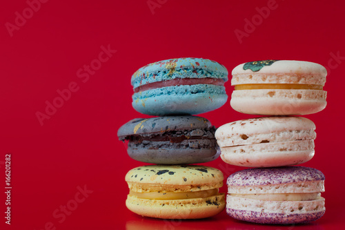 Fototapeta Naklejka Na Ścianę i Meble -  Macarons on red background, Beautiful dessert, six different flavors