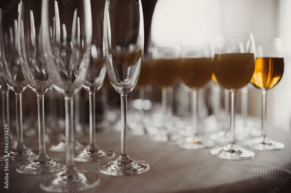 Glasses with alcohol and different drinks, glasses of wine and champagne are on the buffet table Glasses with alcohol and different drinks, glasses of wine and champagne are on the buffet table