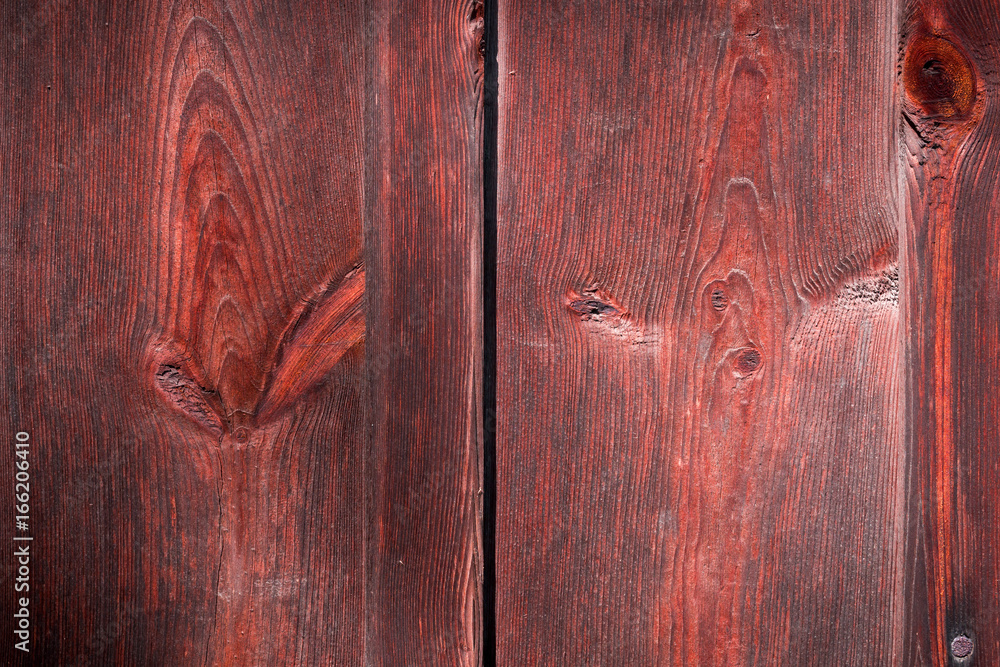 The old red wood texture with natural patterns The old red wood texture with natural patterns