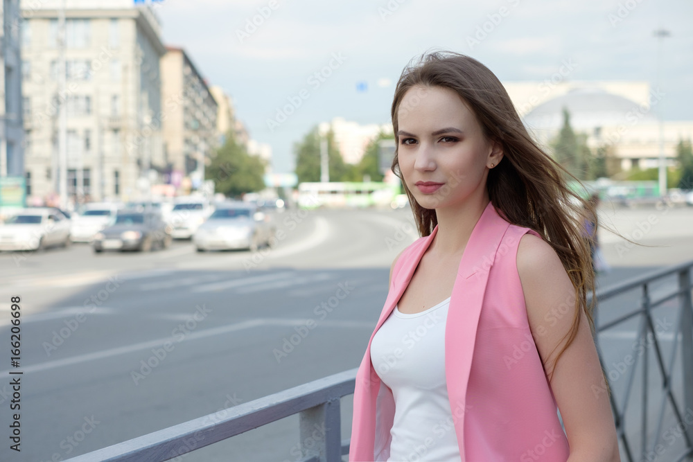Young woman posing on road background