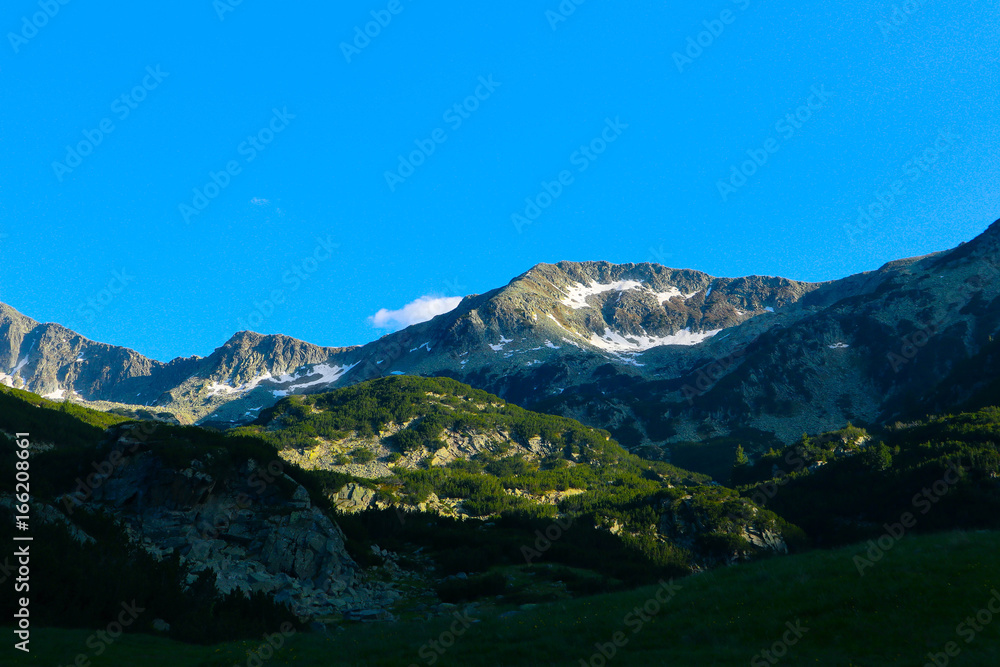 Fototapeta premium Beautiful view on the high green mountains peaks, on the blue sky background. Mountain hiking paradise landscape, no people.