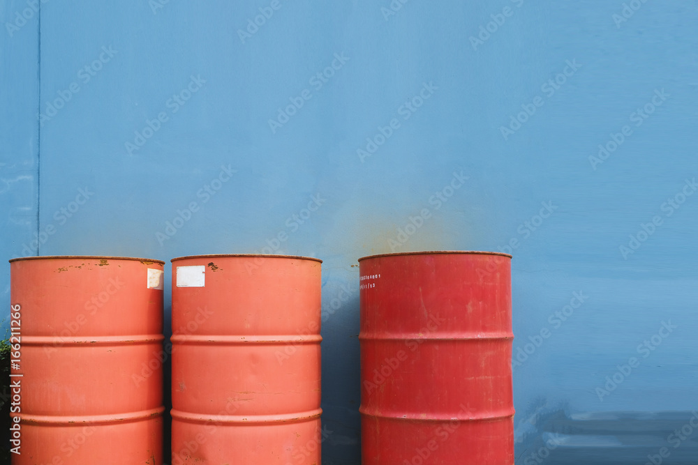 Naklejka premium Three red tank of fuel on blue background.