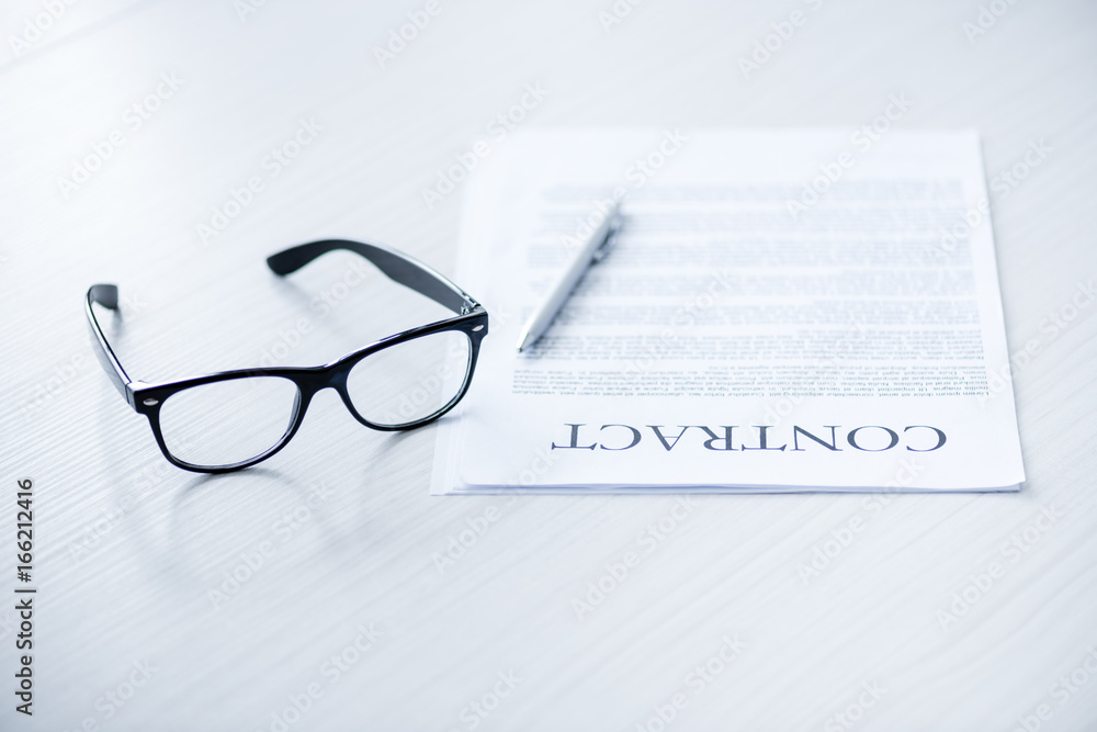 composition with eyeglasses and business documents on white desk composition with eyeglasses and business documents on white desk