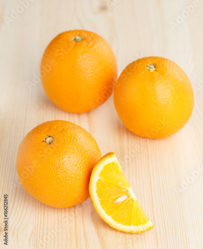 Oranges group freshly on a wooden table. Half of orange on the wooden table. Empty ready for your orange
