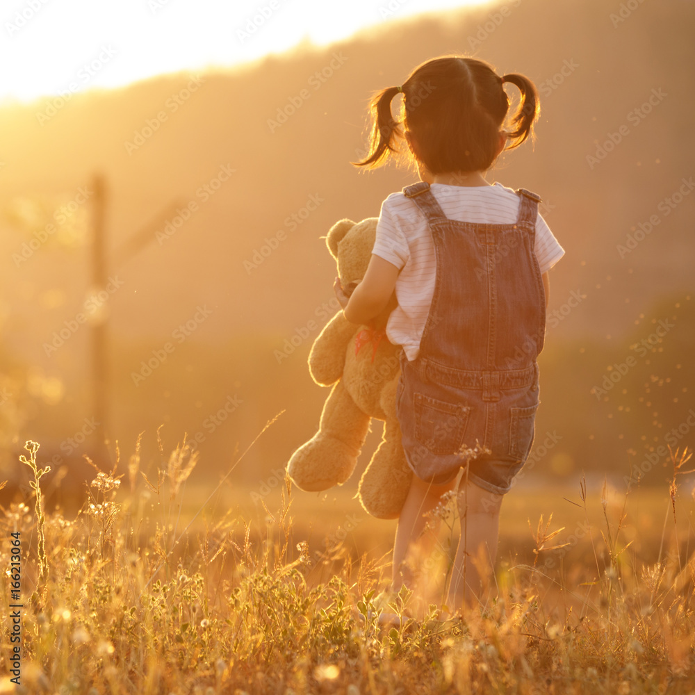 Sad little girl feeling alone in the park concept. Lonely ...