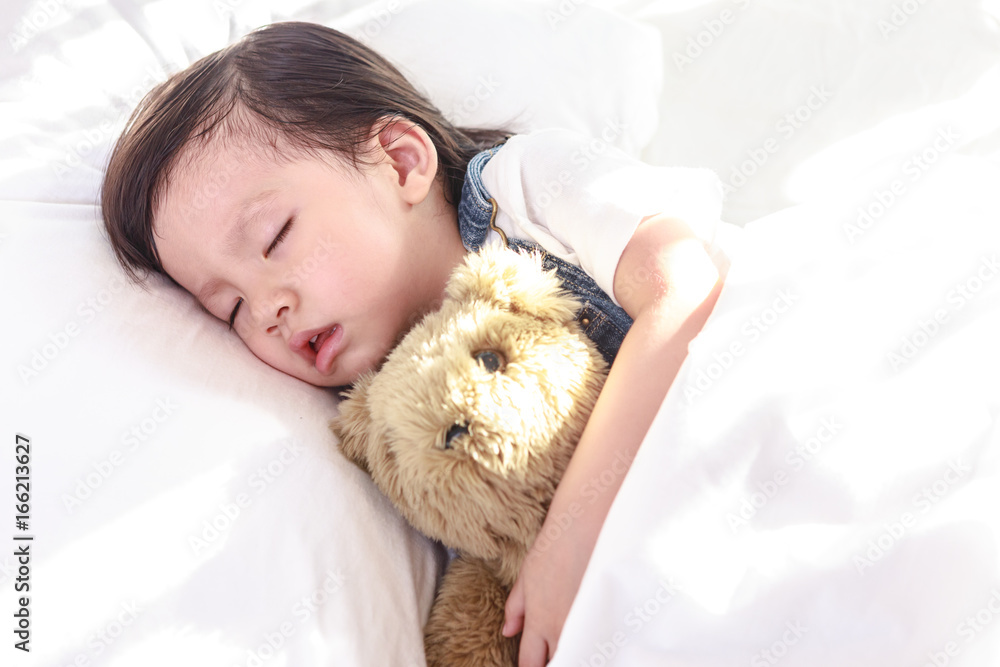 Little asian girl sleeping with her toy teddy bear Little asian girl sleeping with her toy teddy bear