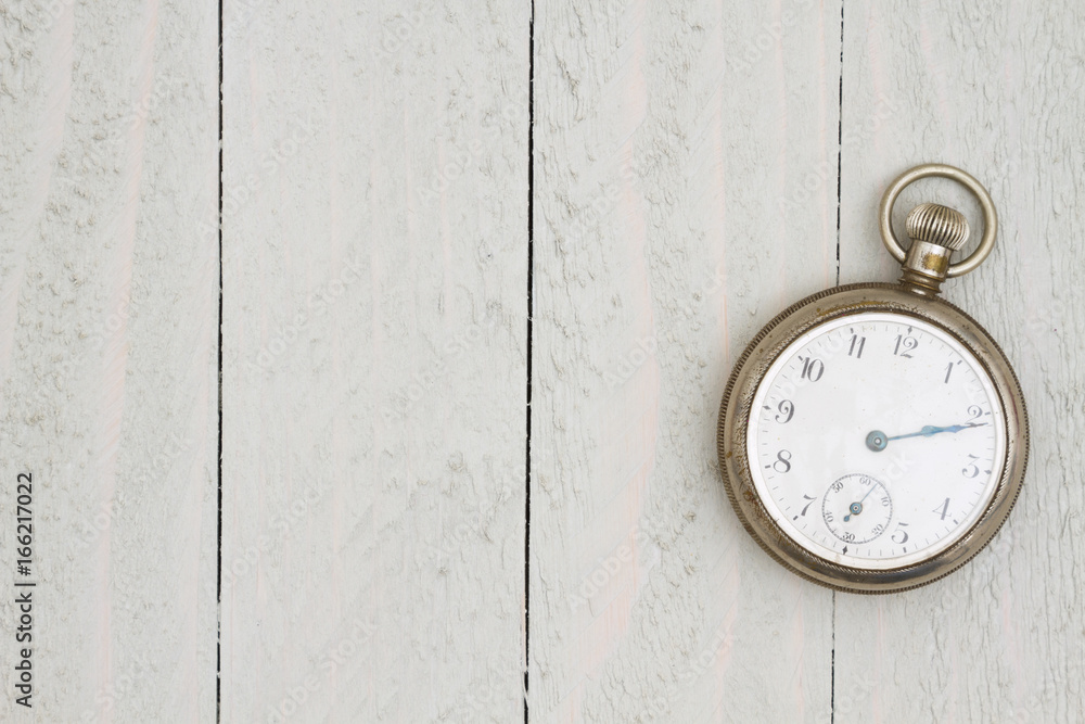 Retro silver pocket watch on weathered wood Retro silver pocket watch on weathered wood