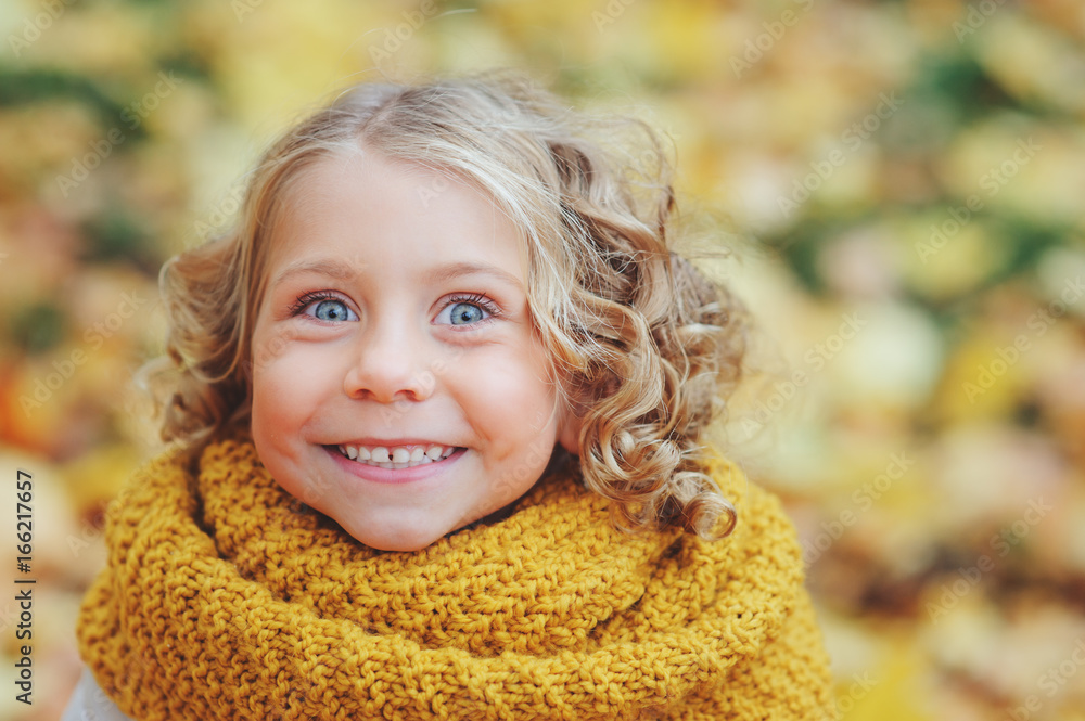 funny autumn portrait of happy toddler girl walking outdoor in stylish orange snood funny autumn portrait of happy toddler girl walking outdoor in stylish orange snood