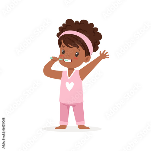 Adorable black cartoon girl in a pink pajamas brushing her teeth, kids dental care vector Illustration