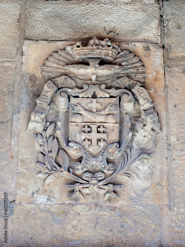 Silent streets in the old city of Jerusalem, Israel. The coat of arms on the wall of the house on Via Delorosa photo