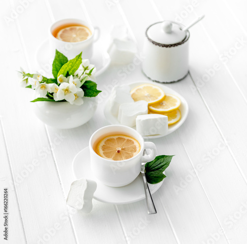 Cups of green herbal tea, jasmine flowers