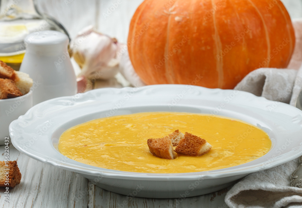 Homemade pumpkin cream soup with garlic croutons. A rustic style. Selective focus Homemade pumpkin cream soup with garlic croutons. A rustic style. Selective focus