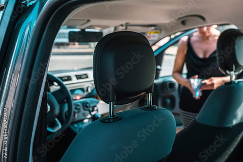 Car interior with woman reading book. Summer vacation tourism on the road. © ysbrandcosijn