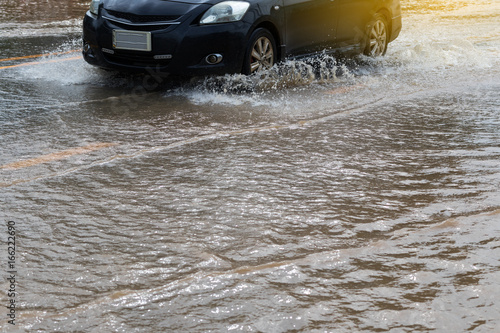 Wheels car sped through flooded. © kaentian