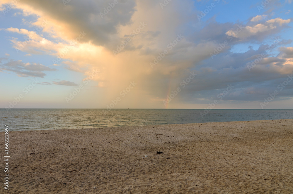 Dirty brown sand beach,rainbow