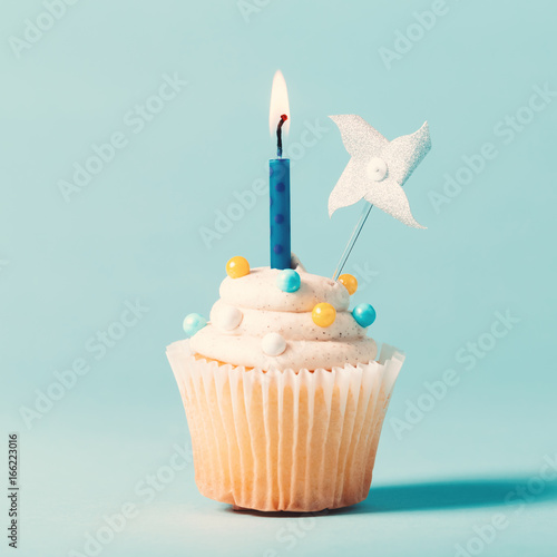 Cupcake with candle celebration theme on a blue background