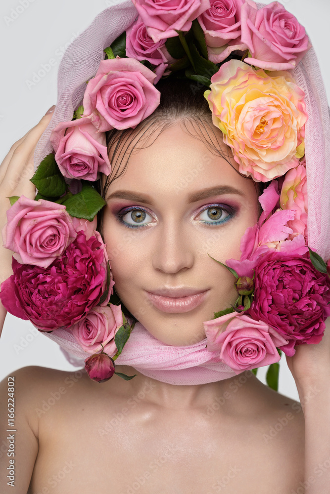 Studio portrait of a beautiful young woman. Fashionable brunette model with nude pink lips and perfect colorfull makeup in scarf on head Studio portrait of a beautiful young woman. Fashionable brunette model with nude pink lips and perfect colorfull makeup in scarf on head
