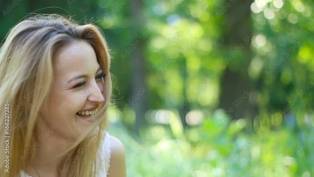 Portrait of attractive laughing woman in park. Outdoors Portrait of attractive laughing woman in park. Outdoors