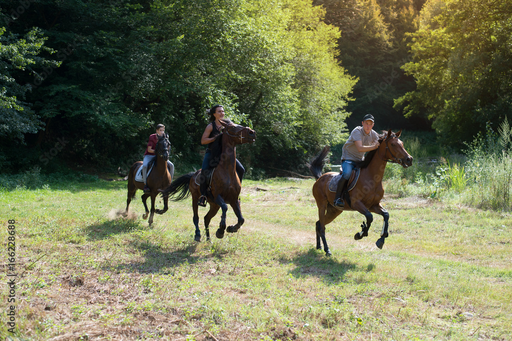 Group of friends riding horses on the river Group of friends riding horses on the river