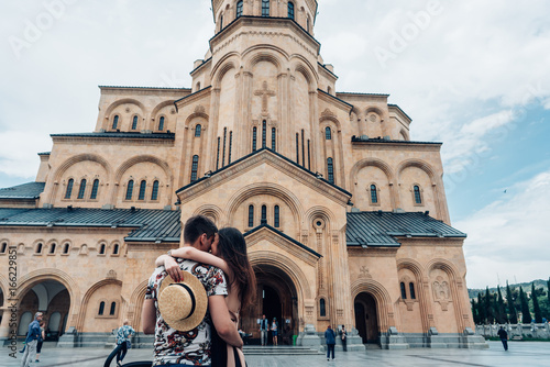 Young couple in love, hugging on the street. © teksomolika